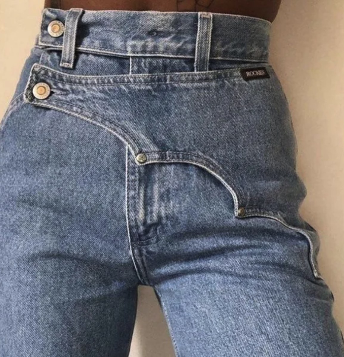 Close-up front view of Rockies double-waistband jeans with curved scoop pocket in medium blue acid-wash denim